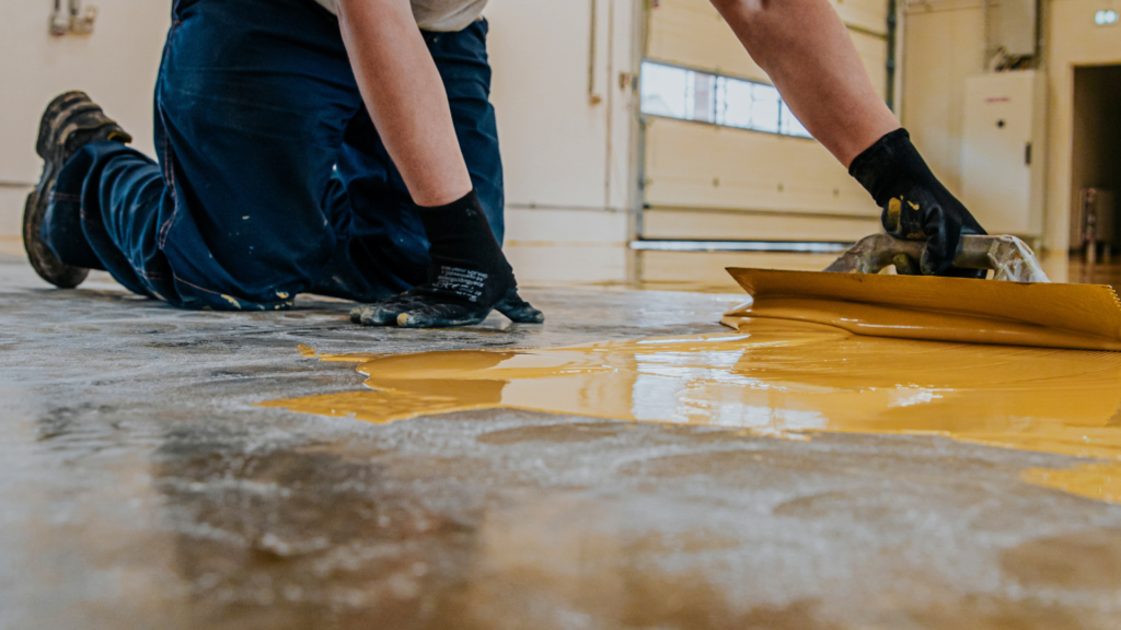 Metallic garage coating being applied by experts from Gold Star Epoxy Flooring