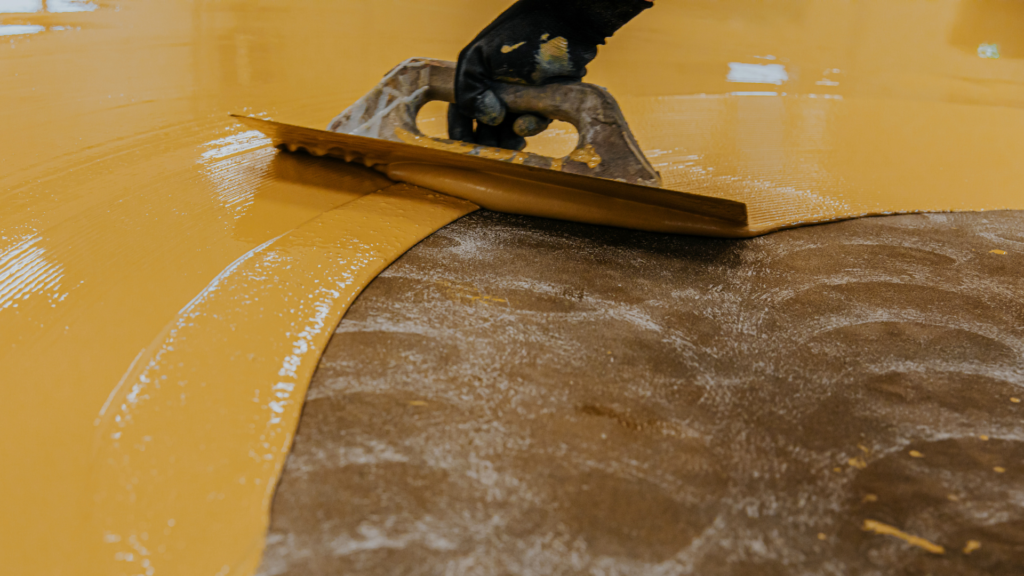 Epoxy floor coating being applied by experts of Gold Star Epoxy